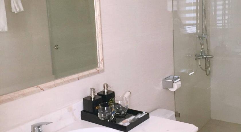 a bathroom with a sink, toilet and mirror, Sun halong hotel in Hạ Long