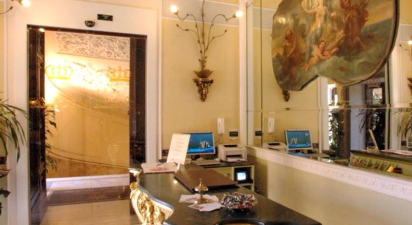 a room with a table, chairs, and a painting on the wall, Art Resort Galleria Umberto in Naples