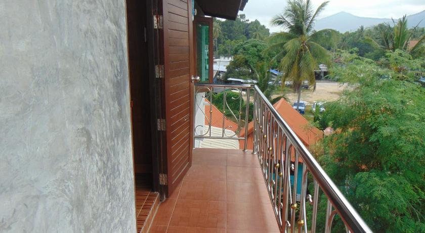 a walkway leading to a balcony overlooking the ocean, Phatchara Boutique Hotel in Ko Pha-ngan