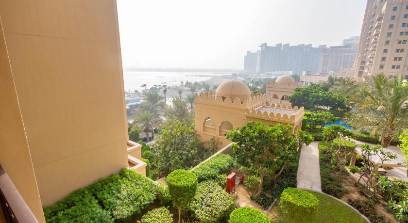 a garden filled with lots of plants next to a building, 2 Bedroom Apartment with Beach Access FS319 in Dubai