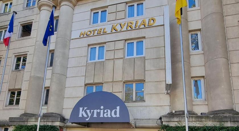 a large building with a flag on the front of it, Hotel Kyriad Montpellier Centre - Antigone in Montpellier
