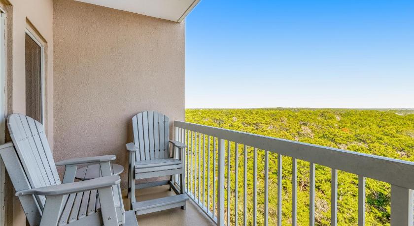 a white chair sitting in front of a balcony overlooking the ocean, TOPS'L Summit VI in Destin (FL)