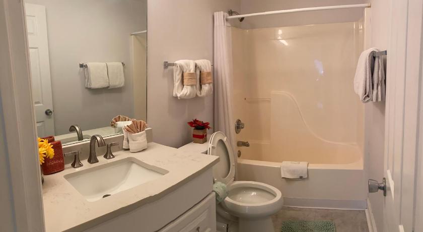 a bathroom with a toilet, sink, and shower, River Place Condos 711 3BD in Pigeon Forge (TN)