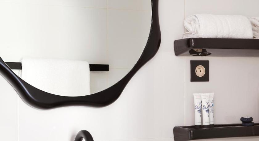a bathroom sink with a mirror above it, Hotel Bienvenue in Paris