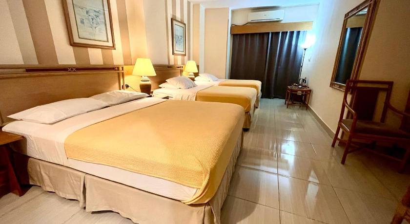 a hotel room with two beds and a large window, Masaya Hurghada in Hurghada