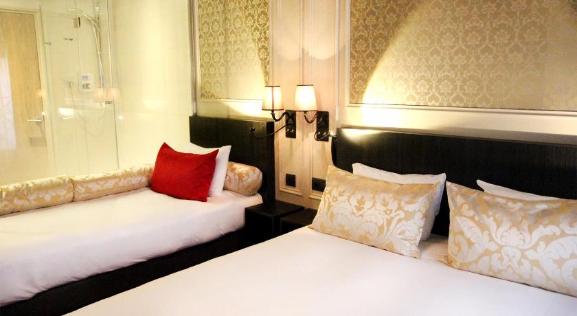 a hotel room with two beds and two lamps, Best Western Hotel Le Montmartre Saint Pierre in Paris