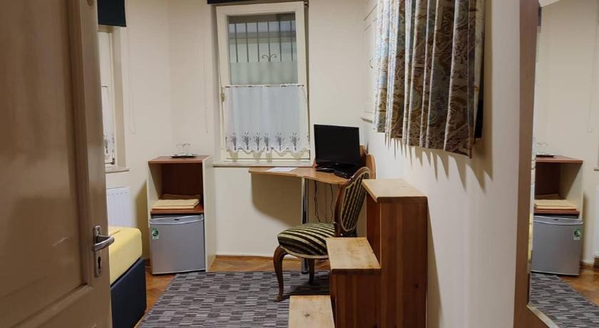 a room with a desk and a chair in it, Barokk Antik Guest Hause in Kecskemet