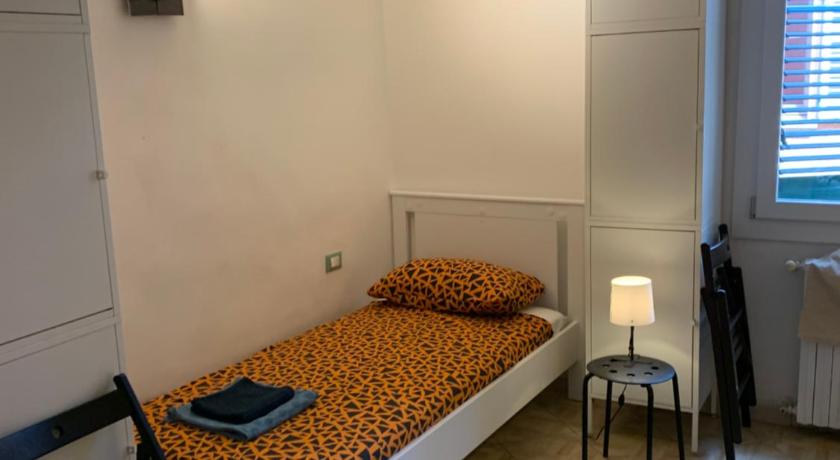 a bedroom with a bed and a desk, Verdi Plaza in Bologna