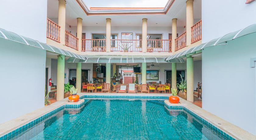 a swimming pool with a pool table and chairs inside of it, Reddoorz Plus Evergreen boutique Hua Hin in Hua Hin / Cha-am