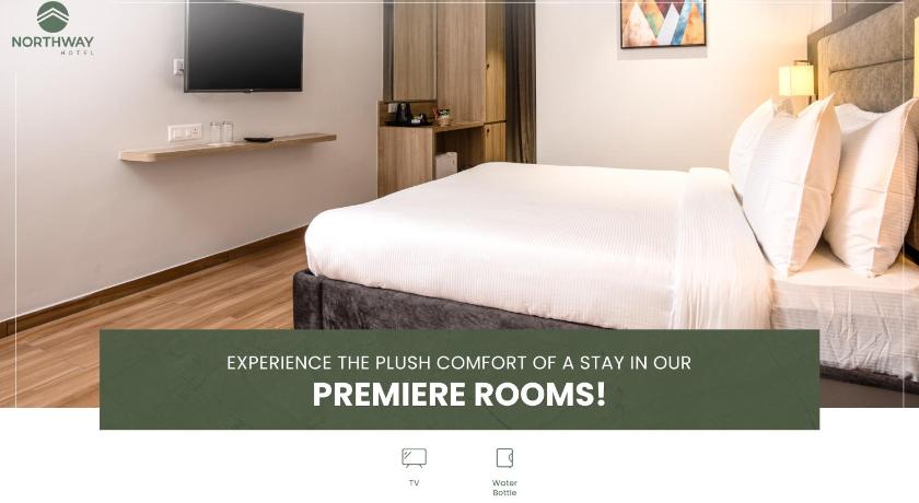 a hotel room with two beds and a television, Northway Hotel in Visakhapatnam