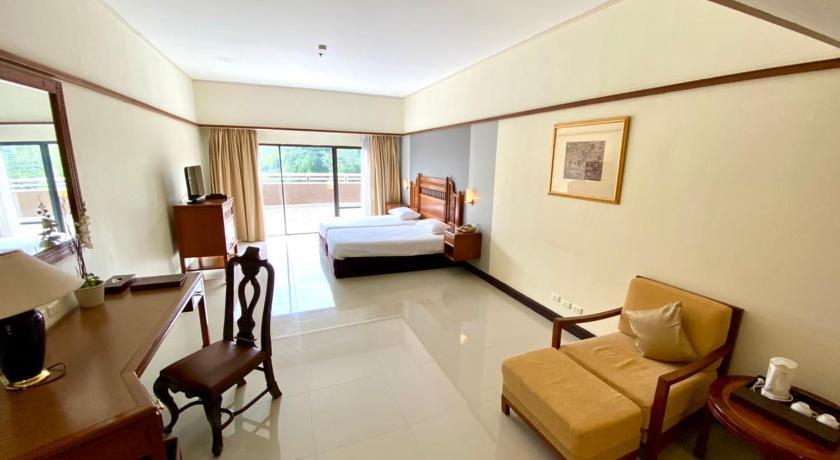 a living room filled with furniture and a large window, Loei Palace Hotel (SHA Extra Plus) in Loei