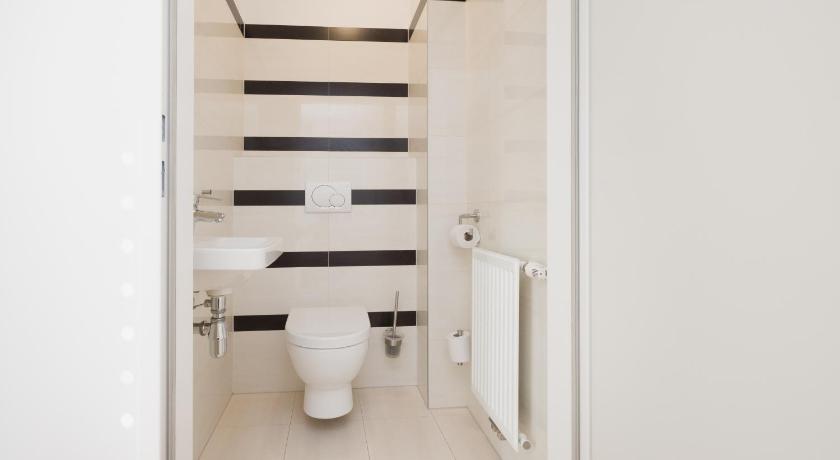 a white toilet sitting in a bathroom next to a wall, Vienna Stay Apartments Pezzl 1170 in Vienna