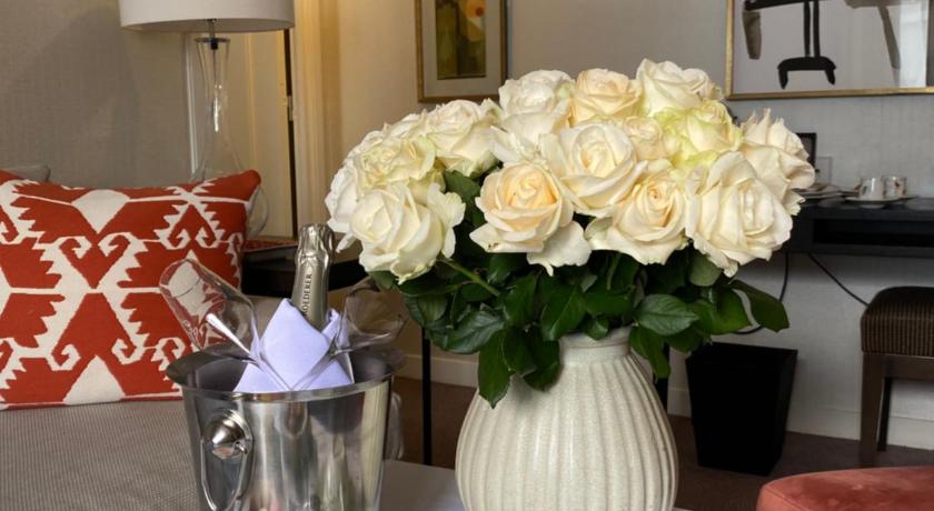 a table with a vase with flowers on it, Hotel Balmoral Champs-Elysees in Paris