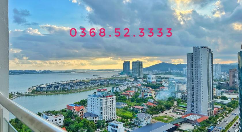 a cityscape of a city with buildings and water, Halong Bay Luxury Apartment in Hạ Long
