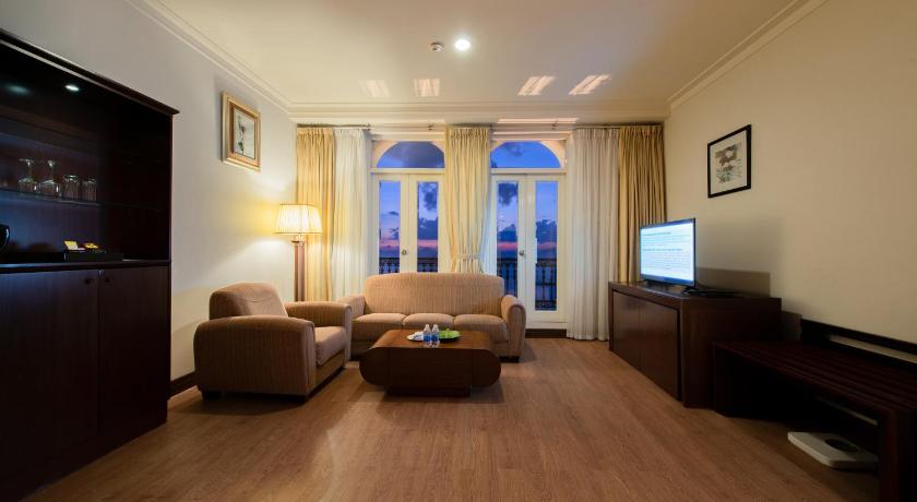 a living room filled with furniture and a tv, Sunrise Nha Trang Beach Hotel & Spa in Nha Trang