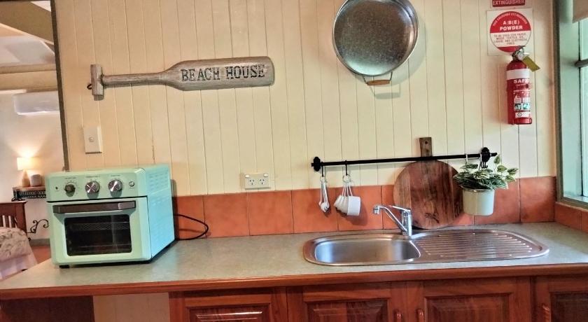 a kitchen counter with a sink and a microwave, Kalimna Woods Cottages in Lakes Entrance