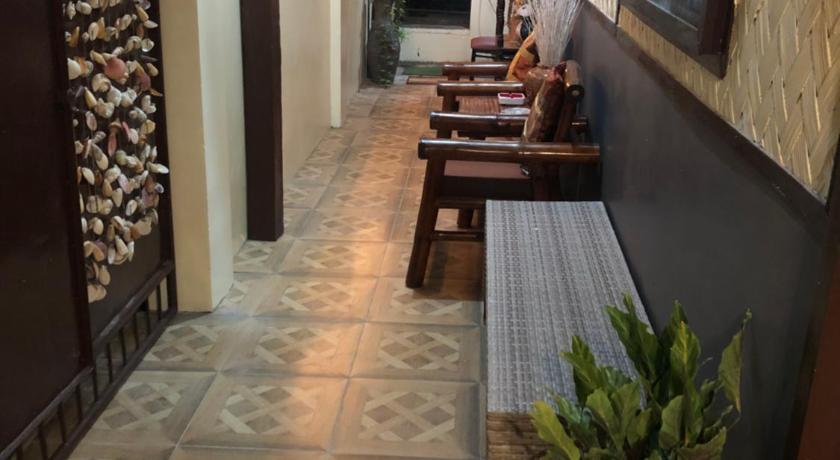 a room with a table, chairs, and a clock on the wall, HIRAYA HOMESTAY by The Yellow House Coron in Palawan