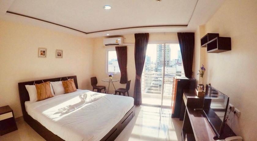 a hotel room with a large bed and a large window, The Cosy River in Bangkok