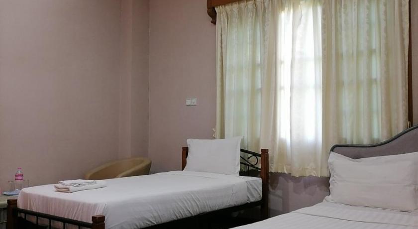 a hotel room with two beds and a desk, Shwe War Guest House in Yangon