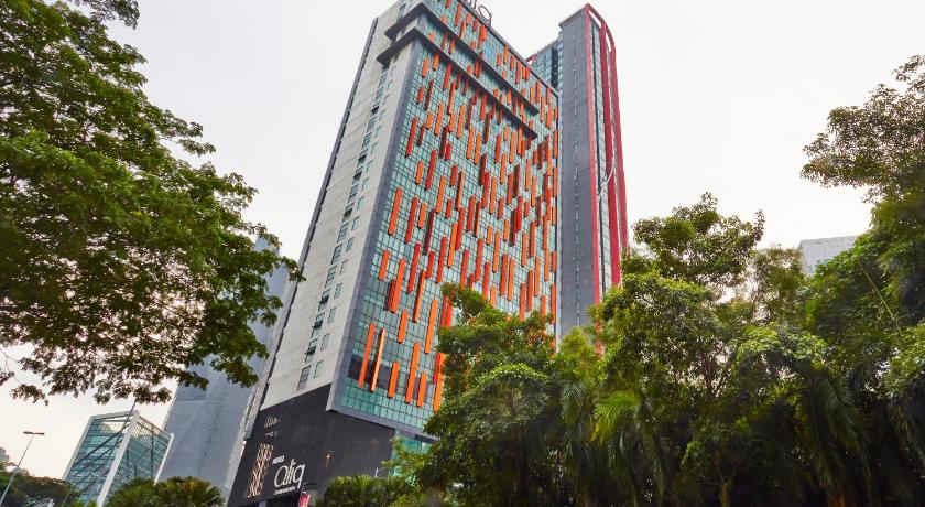 a tall building with a clock on the side of it, Qliq Damansara Hotel in Kuala Lumpur
