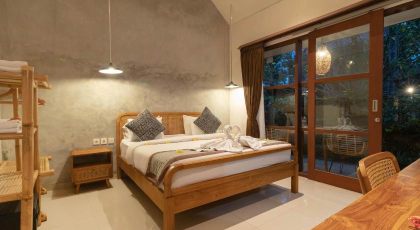 a bedroom with a large bed and a large window, Yarama Cottages in Bali
