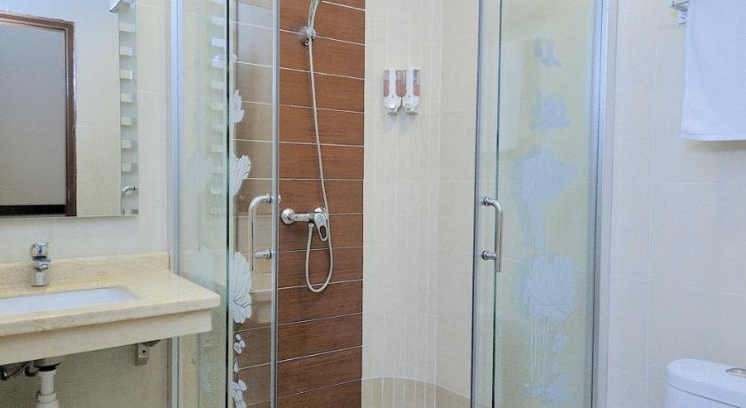a bathroom with a shower, toilet and sink, Ming Paragon Hotel in Kuala Terengganu