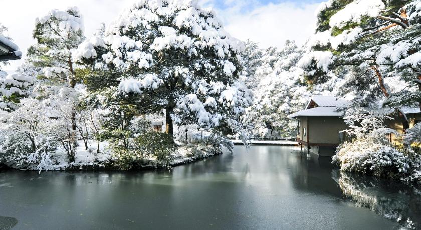 a river filled with lots of snow next to a waterfall, Ryokan Matsusaki in Kaga