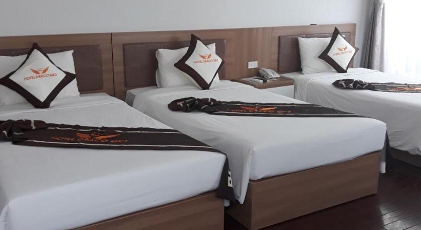 a hotel room with two beds and two lamps, Draco QK3 Hotel in Cat Ba Island