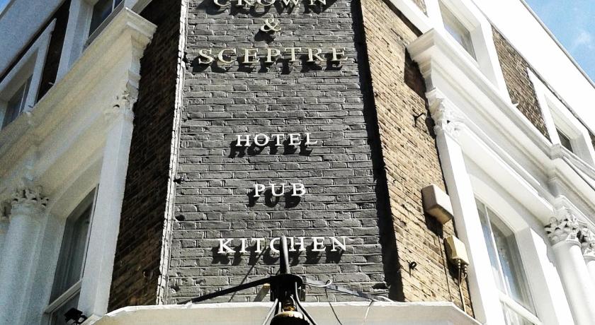 a street sign on a building, The Crown and Sceptre in London