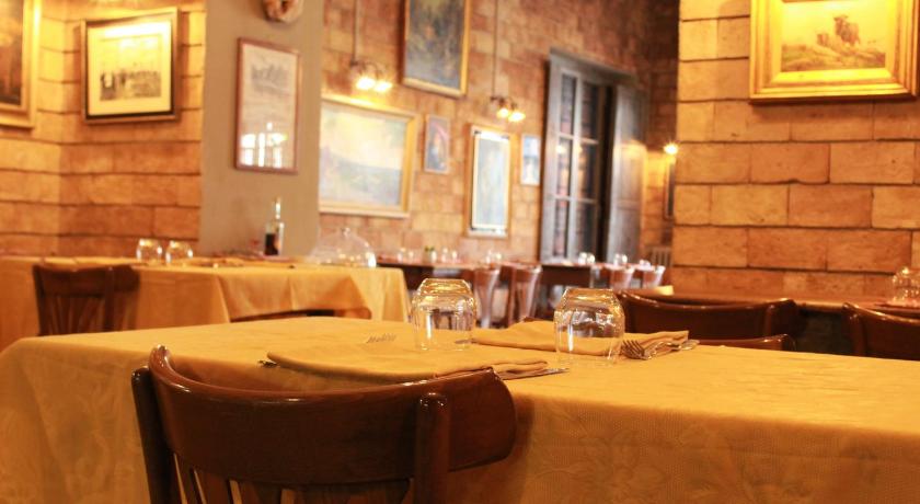 a restaurant with tables and chairs in it, Hotel Ristorante Benigni in Campagnano Di Roma