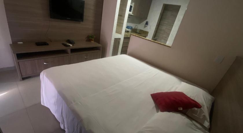 a hotel room with a white bed and white walls, Apart Hotel Garvey - Ciany in Brasilia