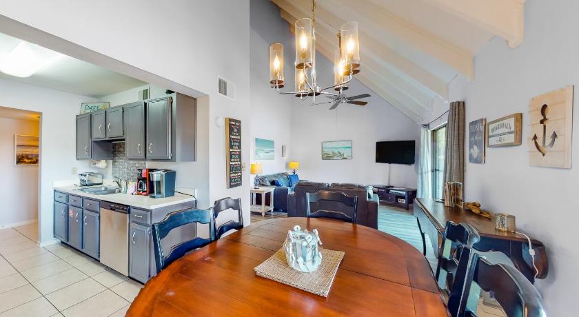 a kitchen with a table, chairs and a refrigerator, Seascape Golf Villas 98C in Destin (FL)