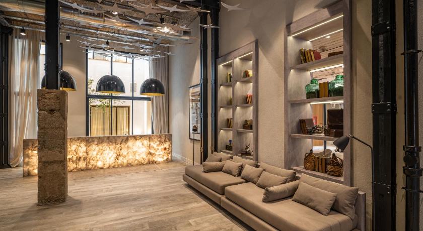 a living room filled with furniture next to a window, Efe Hotel & Cowork in Buenos Aires