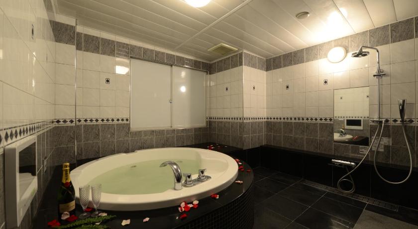 a bath room with a large tub and a large mirror, Hotel S-CUBE (Adult Only) in Bando