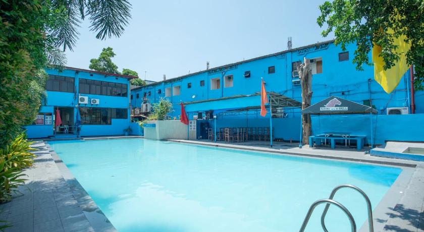 a blue and white swimming pool with a blue boat in the water, OYO 195 Ranchotel - BiÃ±an in Binan