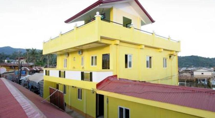 a yellow building with a yellow roof and yellow walls, Luis Bay Travellers Lodge in Palawan