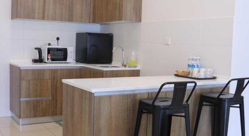 a kitchen with a table and a microwave, ATS Cameron Hotel & Apartments in Cameron Highlands
