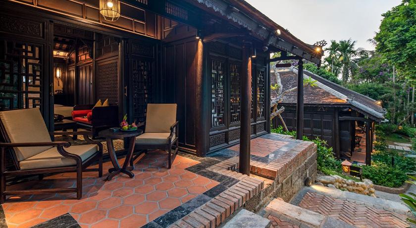 a patio area with a patio table, chairs and a fire hydrant, Ancient Hue Garden Houses in Hue