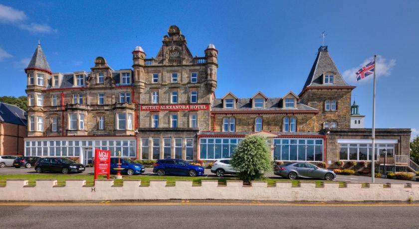 a large building with a clock on the front of it, Muthu Alexandra Hotel in Oban