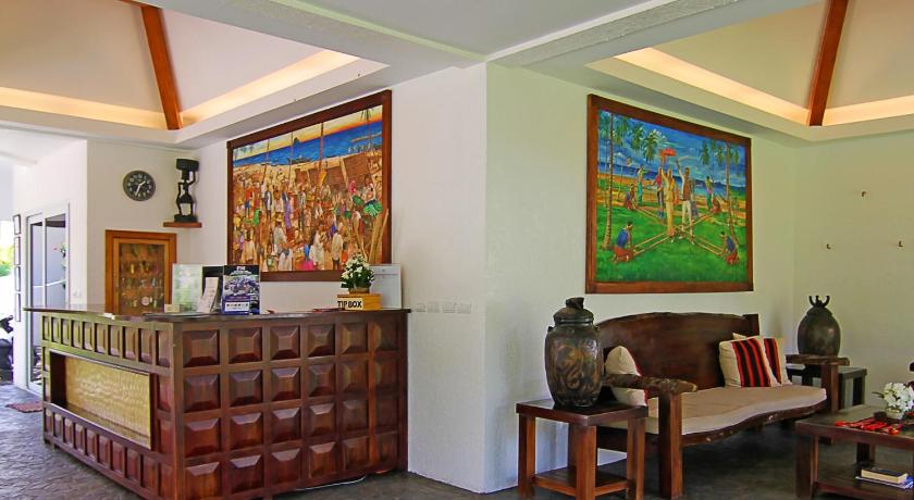 a living room filled with furniture and a painting on the wall, Vida Homes Condo Resort Dauin in Dumaguete