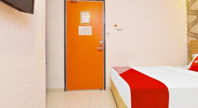 a bedroom with a bed and a door, Super OYO 90512 Sovotel @ Kelana Jaya 79 in Kuala Lumpur