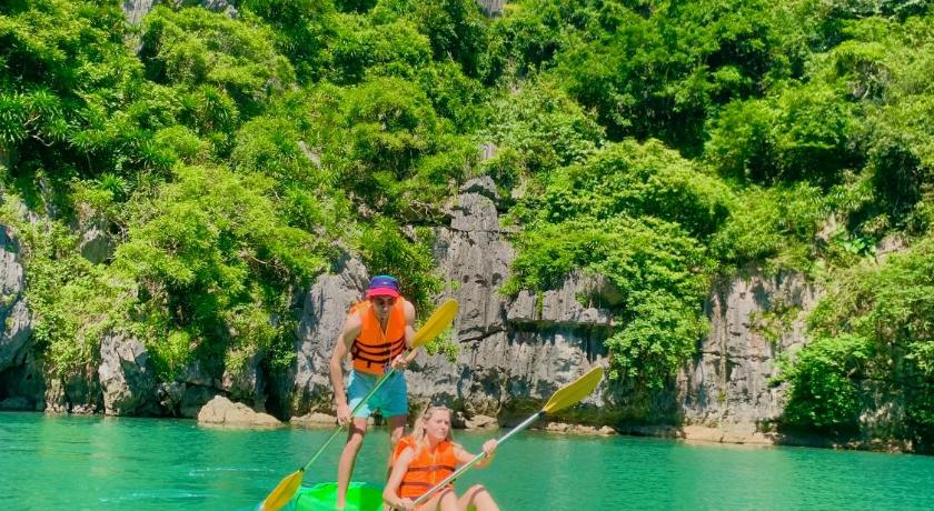 two people on a raft in the water, Viet Hai Lan Homestay in Cat Ba Island
