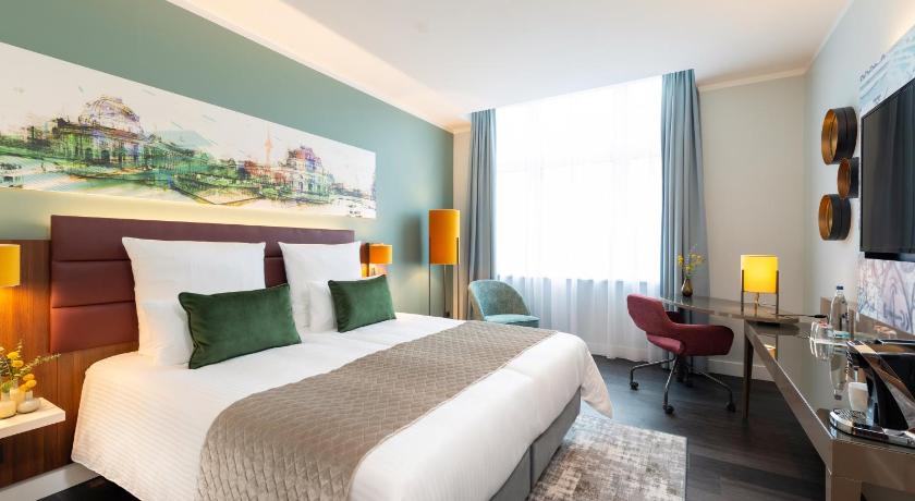 a hotel room with a large bed and a large window, Leonardo Royal Hotel Berlin Alexanderplatz in Berlin