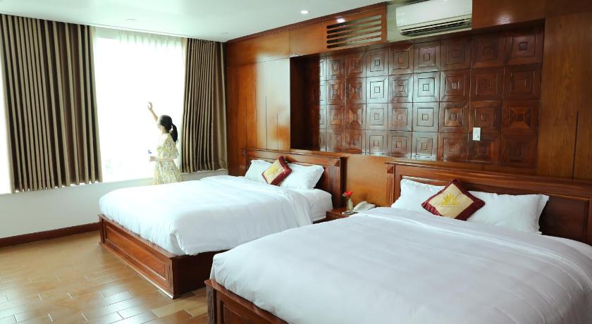 a hotel room with two beds and two lamps, Thành Vinh Hotel & Apartment in Ho Chi Minh City
