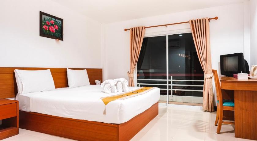 a bedroom with a large bed and a large window, Neptuna Hotel by Maduzi (Patong) (SHA Plus+) in Phuket
