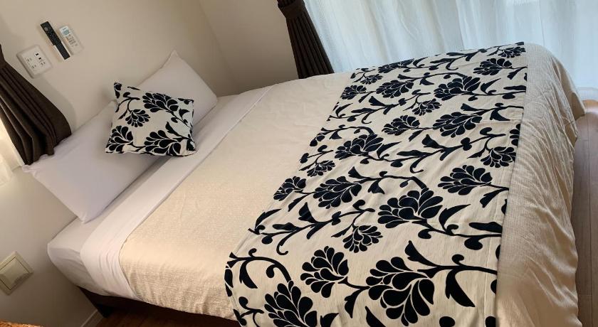 a bed with a white comforter and pillows, HOTEL COZY STAY IN Minatogawa in Okinawa Main island