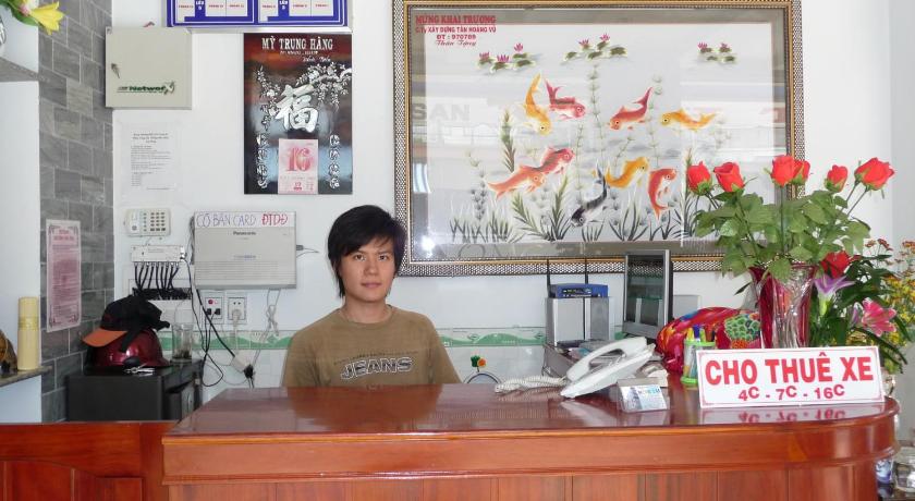 a woman standing in front of a counter in a restaurant, Minh Tai Hotel in My Tho (Tien Giang)