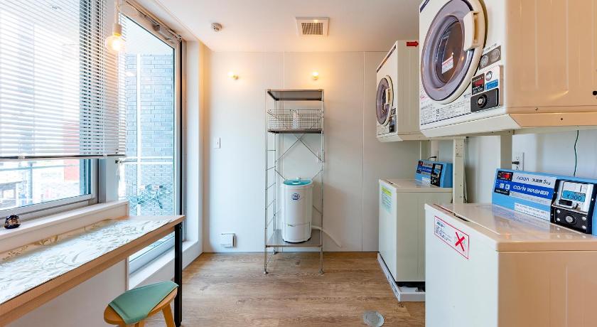 a kitchen with a refrigerator and a sink, plat hostel keikyu kamakura wave in Kamakura