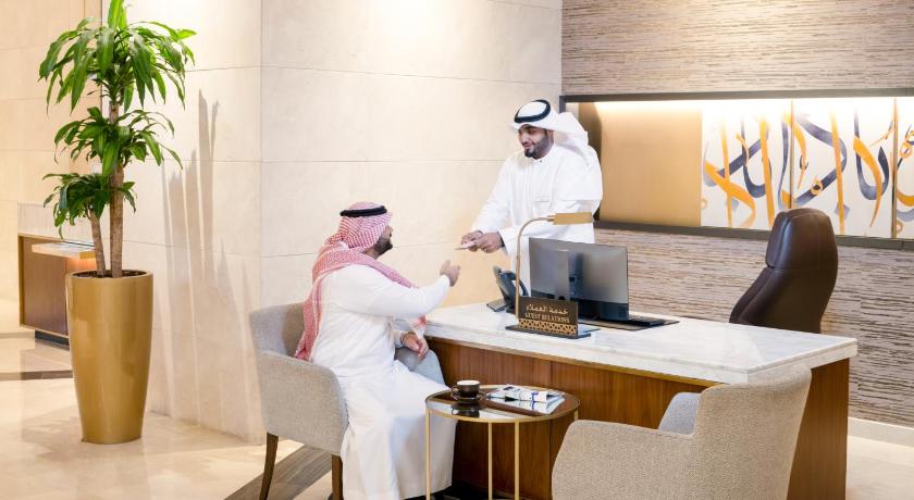 a man and a woman are sitting in a room, Movenpick Hotel & Residence Hajar Tower Makkah in Mecca