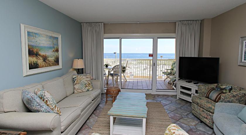 a living room filled with furniture and a tv, Driftwood Towers 1D condo in Gulf Shores (AL)